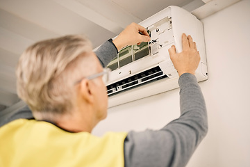 Image showing Maintenance, installation and back of a man with air conditioner for service and ac repair. Building, technician and a handyman fitting an appliance on a wall of a home for home improvement and heat