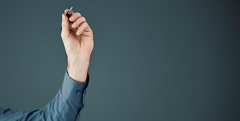 Image showing Business, mockup and hand with pen, space and ideas for opportunity, logo and brand development on dark studio background. Arm, corporate and man make notes, space and product placement on backdrop