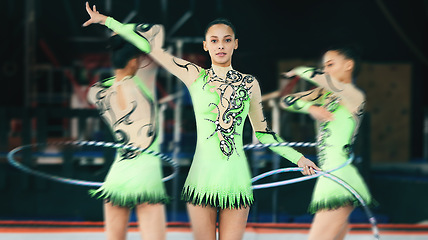 Image showing Sports, gymnastics and woman performing with a hula hoop in a studio with a spinning blur motion. Fitness, gymnast and female athlete practicing agility, skill or flexibility for a routine at a gym.