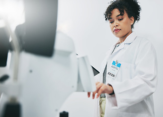 Image showing Healthcare, machine and black woman in laboratory, check experiment and wellness with focus. Medical professional, African American female employee or researcher with lab equipment, testing or typing