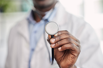 Image showing Hand, stethoscope closeup and doctor with help, healthcare service and black man in hospital. African medic, medical tools and close up for health, wellness and listening to heart, breathing and care