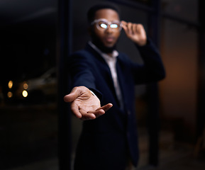 Image showing Businessman, hands and hiring at night for recruitment, opportunity or welcome to the office. Black male with hand out for hire, help or corporate growth on dark background or mockup at the workplace