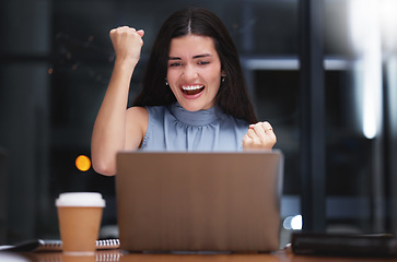 Image showing Laptop, celebration and business woman at night excited for achievement, target goals and stock market profit. Female worker, computer and celebrate success in dark office of winner, bonus and fist