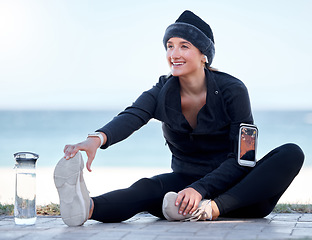 Image showing Fitness, woman and stretching legs by beach in preparation for exercise, cardio workout or training. Happy sporty female in warm up leg stretch getting ready for fun exercising by the ocean on mockup