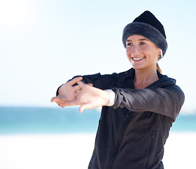 Image showing Fitness, woman and stretching arms on beach in preparation for exercise, cardio workout or training. Happy sporty female in warm up arm stretch getting ready for fun exercising by the ocean on mockup