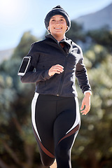 Image showing Running, fitness and woman with lose weight challenge, cardio and exercise in forest with phone for progress. Training, sports and runner person jogging with smartphone technology in park for health