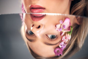 Image showing Beauty, mirror face and model with flower product, sustainable agriculture and natural skincare reflection. Facial makeup, nature plant cosmetics and eco friendly woman isolated on studio background
