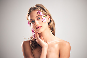 Image showing Beauty, flower and portrait of natural woman in studio for cosmetics, skincare wellness and makeup products. Spring, art and girl with petal on face for spa aesthetic, luxury facial and cosmetology