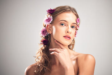 Image showing Portrait, skincare and woman with flowers, cosmetics and dermatology with lady on grey studio background. Face, female and lady with plants, florals in hair or makeup with grooming or morning routine