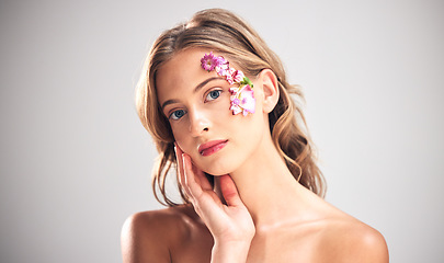 Image showing Beauty, art and portrait of woman with flowers for natural cosmetics, skincare wellness and makeup product. Spring, studio and girl with petal on face for spa aesthetic, luxury facial and cosmetology