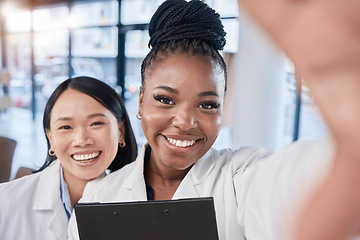 Image showing Doctor, team selfie and women friends with smile, checklist and happy at clinic for profile picture. Medic, asian and black woman with team building, support and solidarity in hospital for portrait