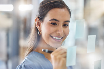 Image showing Strategy, planning and woman writing an idea, schedule or agenda on a sticky note board at work. Goal, creative and employee with an agenda, brainstorming and vision with project management notes