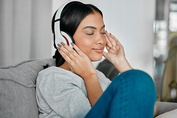 Image showing Music, headphones and woman on sofa in home living room streaming radio or podcast. Relax, technology and female with headset for listening or enjoying song, audio or album on couch in house lounge.