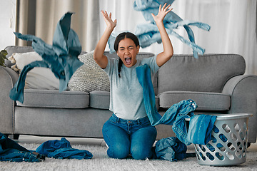 Image showing Laundry, angry and woman with clothes in air frustrated from cleaning, housekeeping and housework. Burnout, washing basket and upset, stressed and shouting female maid in living room throw clothing