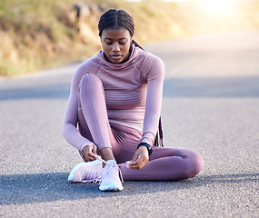 Image showing Fitness, road and black woman tie shoes on street to get ready for running, exercise or workout. Sports athlete, training and female runner tying sneakers to start exercising, cardio or jog outdoors.