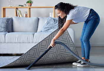 Image showing Woman, vacuum and cleaning carpet floor in housekeeping for clean sanitary hygiene at home. Happy female cleaner in germ or dust removal in living room interior by sofa for daily chores or routine