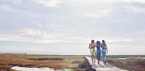 Image showing Relax, happy and boardwalk with friends at beach for travel vacation, support or summer break with sky mockup. Diversity, holiday and nature with women walking together for bonding, hug or peace