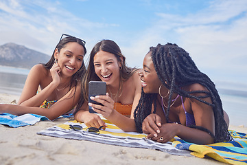 Image showing Girl friends, ocean fun and phone of a teenager laughing at funny meme by the sea in Miami. Travel, vacation and sunshine with happy students enjoying spring break with mobile app lying on sand