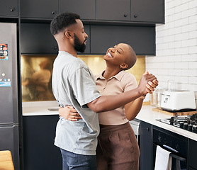 Image showing Dance, love and happy black couple in the kitchen having fun together in their new modern home. Happiness, smile and young African man and woman dancing for romantic or intimate moment in their house