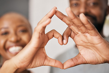 Image showing Happy, hands in heart and black couple with smile for relationship, dating and commitment in home. Love, emoji sign and face of black woman and man with hand shape for bonding, romance and trust