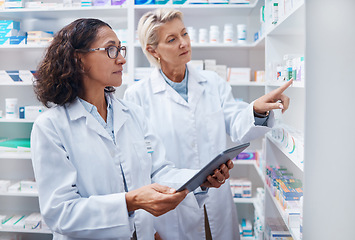 Image showing Tablet, teamwork and pharmacists check stock in pharmacy, drugstore or shop for medication. Medicine, technology and medical doctors or senior women with touchscreen for checking product inventory.