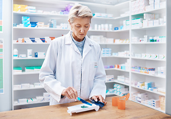 Image showing Pharmacy woman, pills and counting in store for stock, product and medicine for health on table with tools. Pharmacist sorting, management and focus for retail pharma for healthcare service in shop