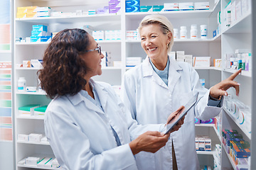 Image showing Doctors, tablet and pharmacist check stock in pharmacy, drugstore or medication shop. Medicine, technology and medical teamwork of happy senior women with touchscreen for checking product inventory.