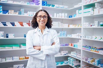 Image showing Senior woman, portrait and pharmacist with arms crossed in pharmacy, drugstore or shop. Healthcare, wellness and happy, proud and confident elderly female medical professional or doctor from Canada.