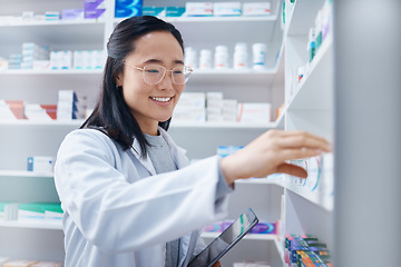 Image showing Asian woman, tablet and pharmacist check stock in pharmacy for healthcare medicine in drugstore. Medication, technology and happy female medical doctor with touchscreen for checking inventory in shop