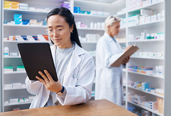 Image showing Tablet, Asian woman and pharmacist in pharmacy for healthcare or online consultation in drugstore. Medication, telehealth technology and female medical doctor with touchscreen for research in shop.