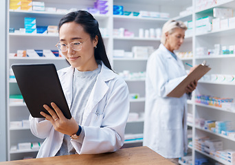 Image showing Asian woman, tablet and pharmacist in pharmacy for healthcare, telehealth or stock check. Medicine shop, technology and female medical doctor with touchscreen for research or online consultation.