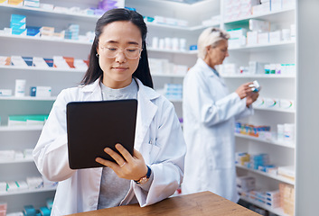 Image showing Asian woman, tablet and pharmacist in pharmacy for healthcare or online consultation in drugstore. Medication, telehealth technology and female medical doctor with touchscreen for research in shop.