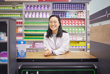 Image showing Pharmacy, smile and portrait of asian woman at counter in drugstore, customer service and medical advice in Japan. Prescription drugs, happy pharmacist and inventory of pills and medicine at checkout