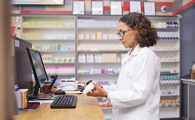 Image showing Order, pills and pharmacist scanning medicine at a checkout for service at a pharmacy. Healthcare, medical and woman on a hospital pc to scan a box for a prescription, inventory and medication check