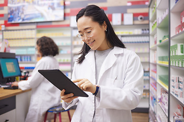 Image showing Pharmacy, tablet and asian pharmacist woman for medicine management, stock research and inventory. Digital technology, retail logistics and healthcare doctor or person with ecommerce product software