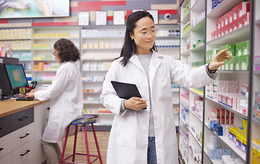 Image showing Pharmacy, tablet and pharmacist woman for medicine management, stock research and inventory data app. Digital technology, retail logistics and asian healthcare doctor or person for product data check