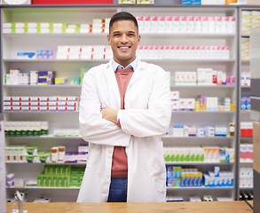 Image showing Pharmacy, smile and confidence, portrait of man at drugstore counter, customer service and medical advice in Brazil. Prescription drugs, pharmacist and inventory of pills and medicine at checkout.