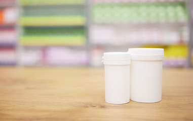 Image showing Pharmacy, medicine and mockup with a tablet containers for pills on a wooden countertop for treatment. Medical, insurance and healthcare in a drugstore with mock up for pharmaceutical advertising