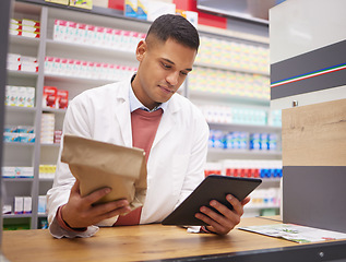 Image showing Pharmacy, tablet and pharmacist doing research on medication on the internet in a clinic. Healthcare, medical and male doctor or chemist reading information on prescription medicine on mobile device.