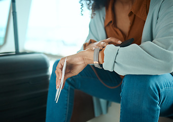 Image showing Black woman, travel and check time, airport and wait to board flight with watch, plan ticket and luggage. Ready for adventure, traveller and vacation with airplane transportation and holiday abroad