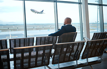 Image showing Airport waiting, black man back and phone for work travel, plane and air flight. Businessman, mobile connection and person sitting with cellphone looking at traveler app info for airplane traveling