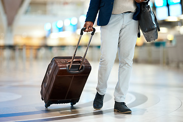 Image showing Luggage, airport and black man travel for business opportunity, international career and immigration. Professional person or entrepreneur legs walking with suitcase for flight, wealth and global job