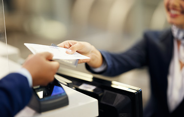 Image showing Hands, airport and passenger assistant with ticket, passport or documents to board plane at terminal counter. Hand of female service agent giving access for travel, security or immigration papers