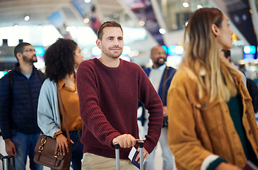 Image showing Travel, queue and smile with man in airport for vacation, international trip and tourism. Holiday, luggage and customs with passenger in line for ticket, departure and flight transportation