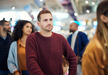 Image showing Travel, queue and serious with man in airport for vacation, international trip and tourism. Holiday, luggage and customs with passenger in line for ticket, departure and flight transportation