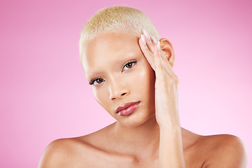 Image showing Portrait, beauty and makeup with a black woman in studio on a pink background for edgy cosmetics. Face, skincare or natural with a unique and attractve young female model indoor for cosmetic care