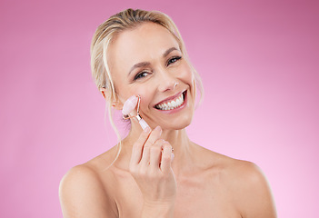 Image showing Beauty, facial roller and woman portrait for face massage with dermatology and cosmetics in studio. Happy aesthetic person on pink background for skincare, self care and rose quartz results for glow