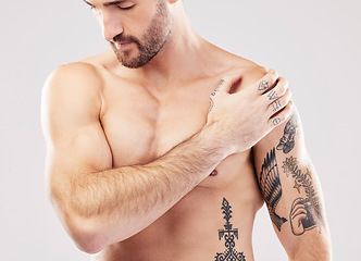 Image showing Injury, feeling and man with arm pain after sports isolated on a grey studio background. Fitness, accident and person touching a shoulder with a broken bone, body strain and problem after workout