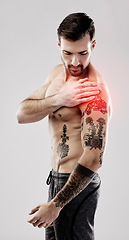 Image showing Injury, feeling and a man with arm pain and muscle sprain isolated on a grey studio background. Emergency, broken bone and person touching a painful, swollen and hurt area in the body on a backdrop