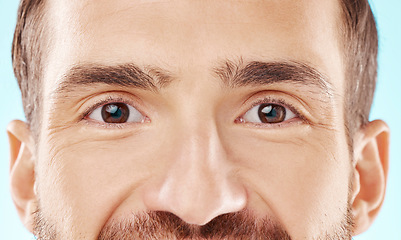 Image showing Skincare, vision and zoom on man eyes, beauty and grooming portrait isolated on blue background. Eye care, health and facial wellness, good eyesight and glowing skin on happy male model in studio.